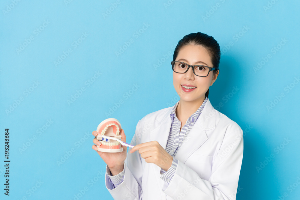 pretty attractive doctor woman using toothbrush