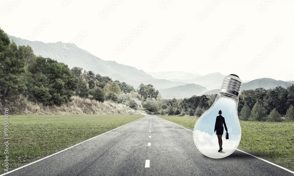 Businesswoman inside light bulb