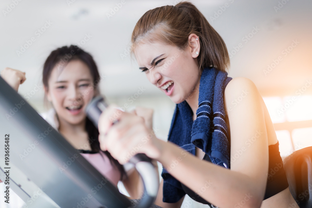 caucasian sport woman in training on bicycle with cheerup from friend