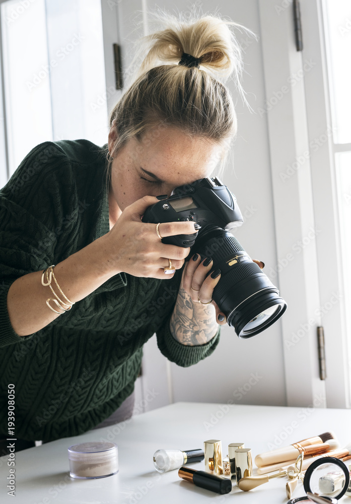 Beauty blogger taking photo of cosmetics