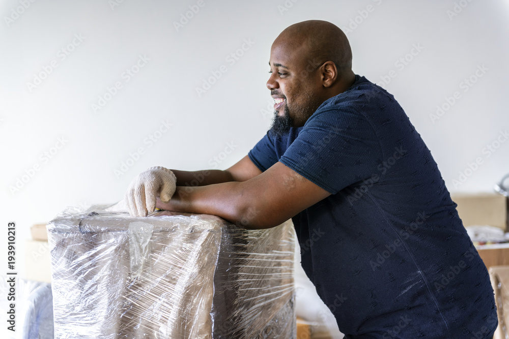 Black man moving furniture