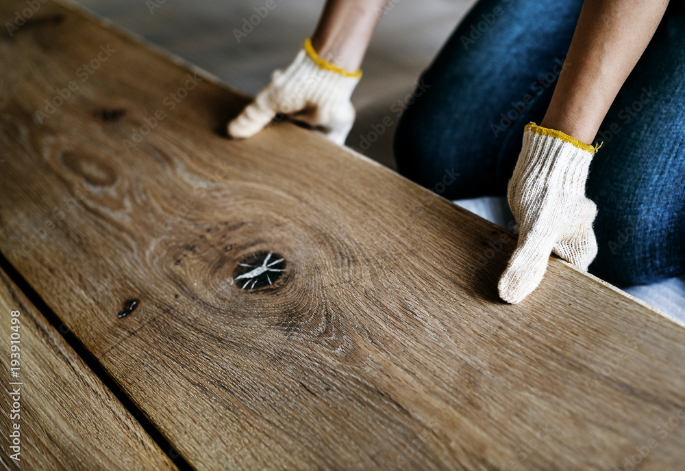 Carpenter man installing wooden floor