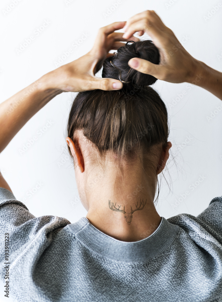 Woman putting her hair up in a bun