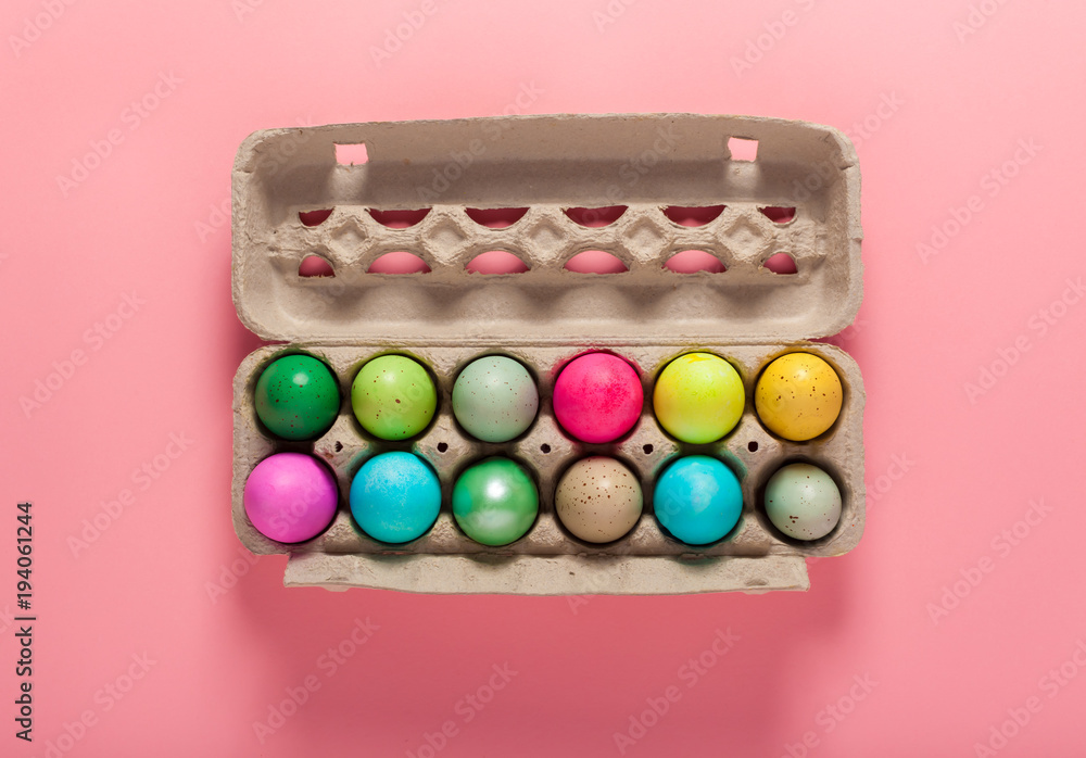 Painted Easter eggs arranged on a pink background