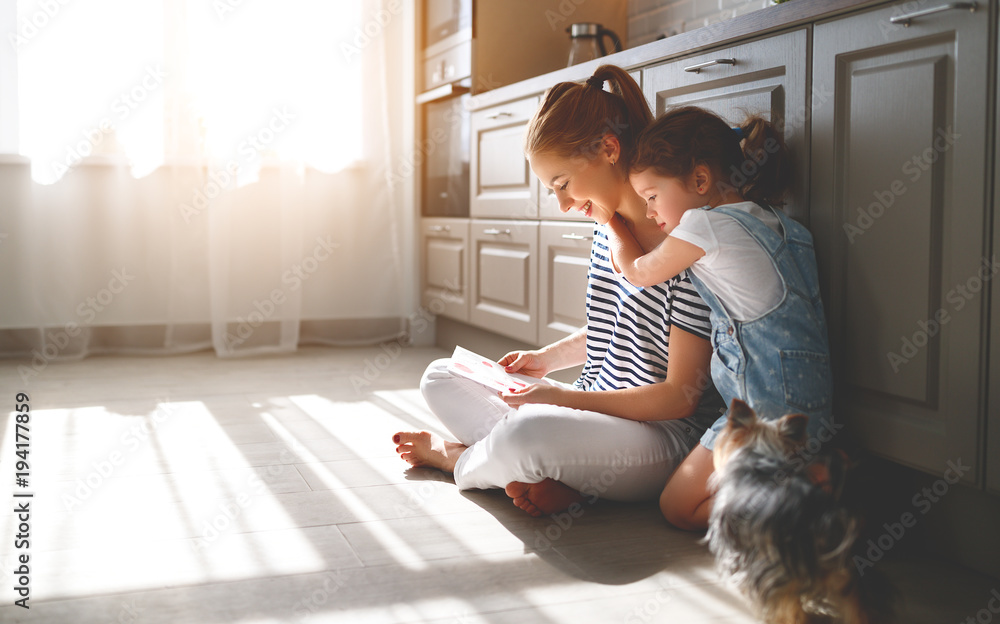 happy mothers day! child daughter congratulates her mother and  read postcard