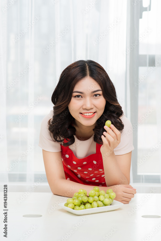 Lovely young woman with green grape. Healthy vegetable eating