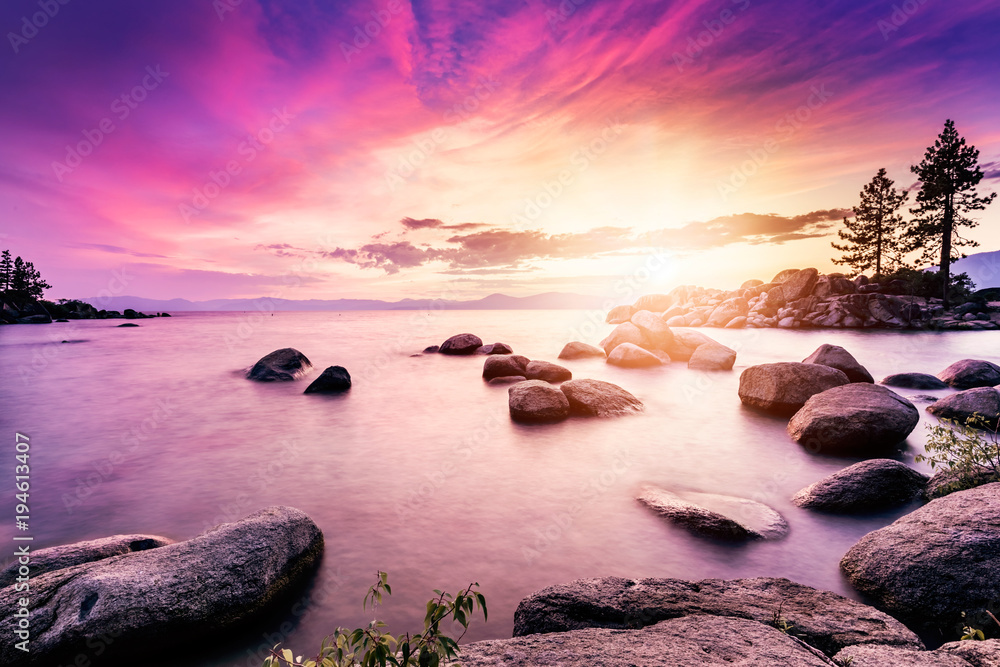 Lake Tahoe sunset photographed from San Harbor beach, long exposure with sunset colors reflecting in