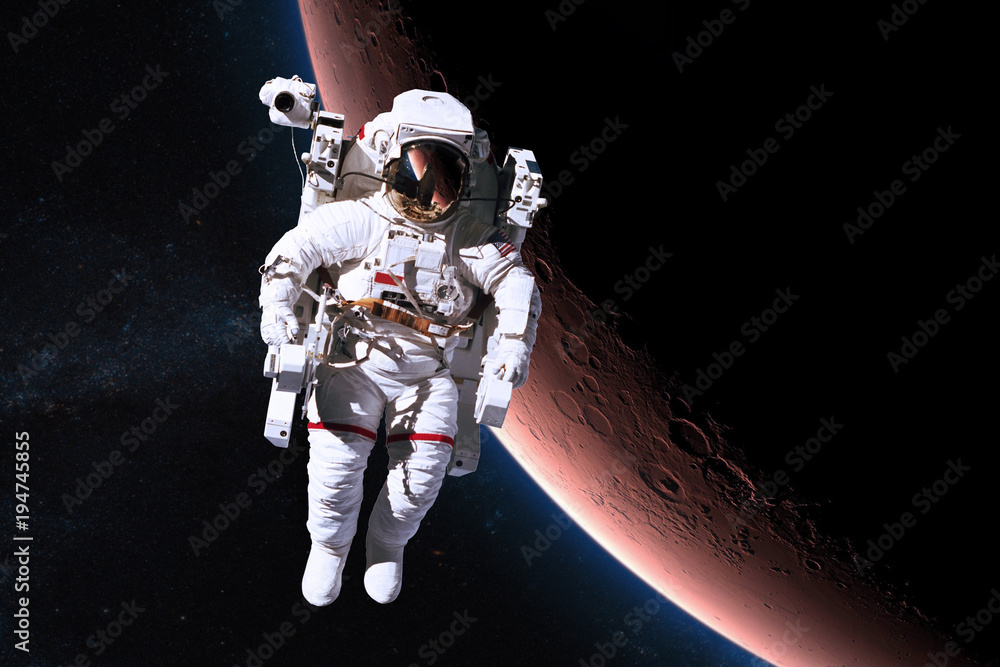 Astronaut in outer space on background of the Mars. Elements of this image furnished by NASA.