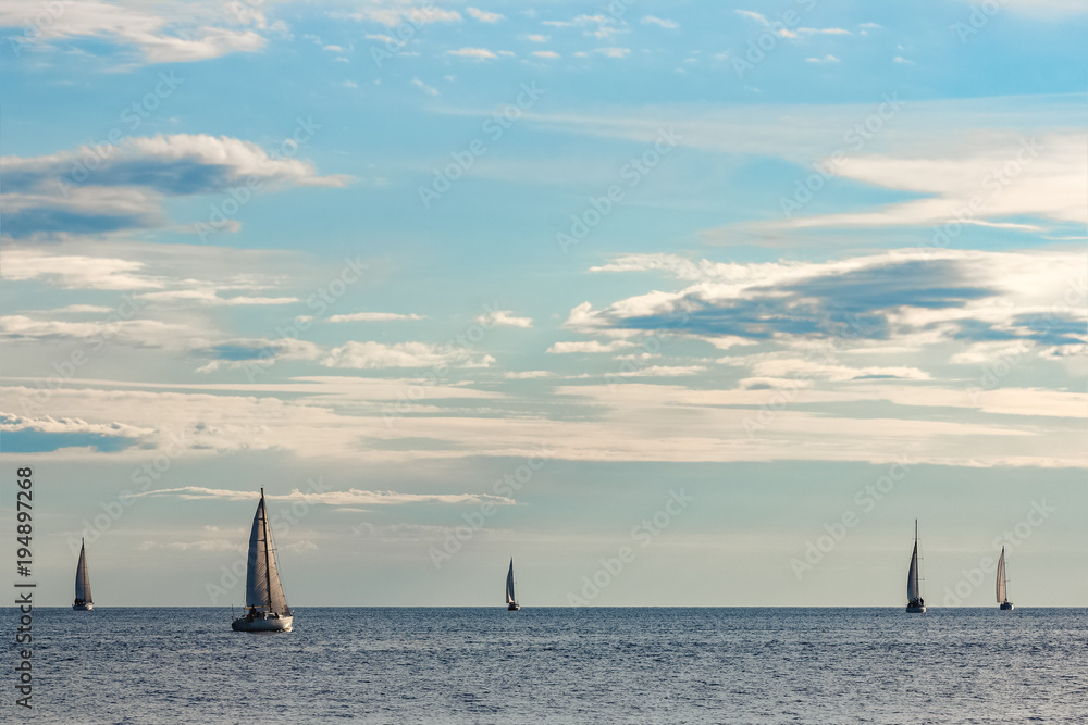 Sailboats traveling by Baltic sea