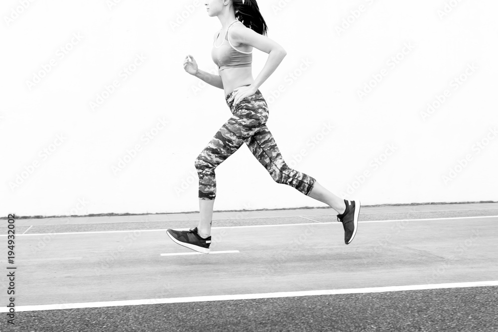 White woman running on track