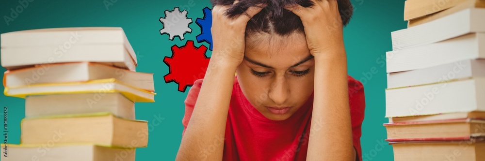 Boy reading between two piles of books and cogs on a green