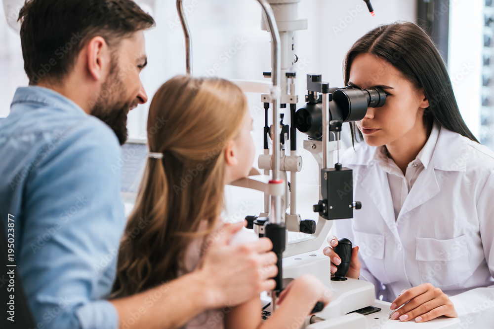 Dad with daughter in ophthalmology clinic