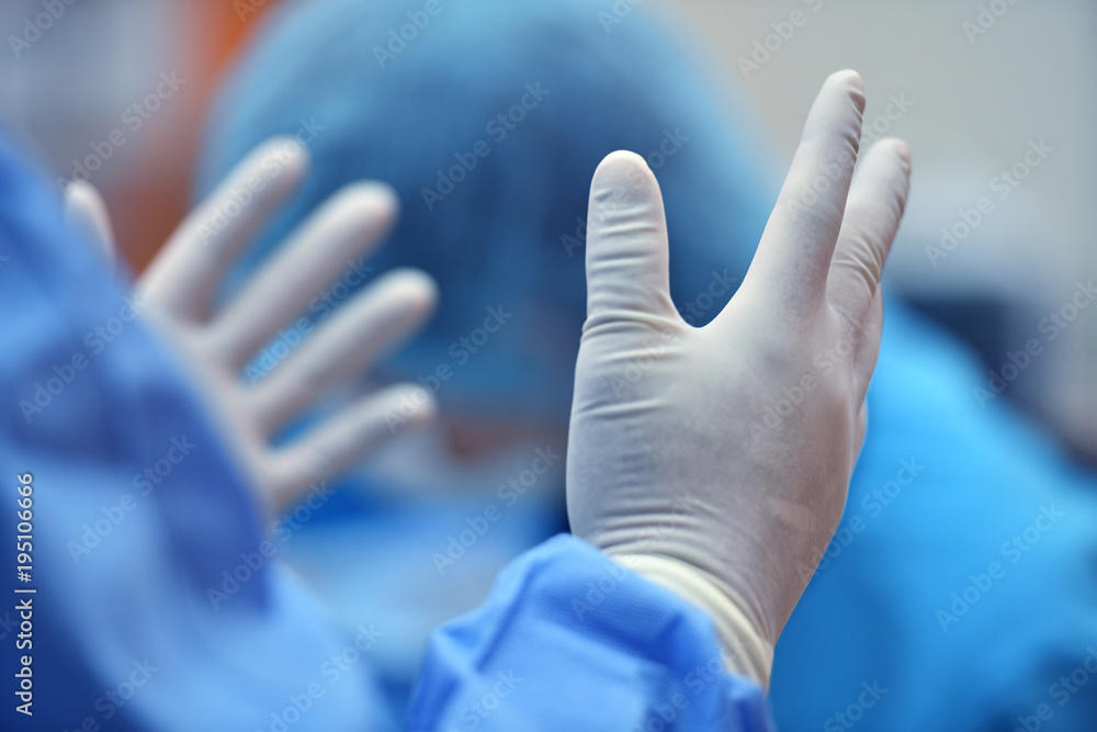 Surgeon hand putting on a grove and preparing for a surgery