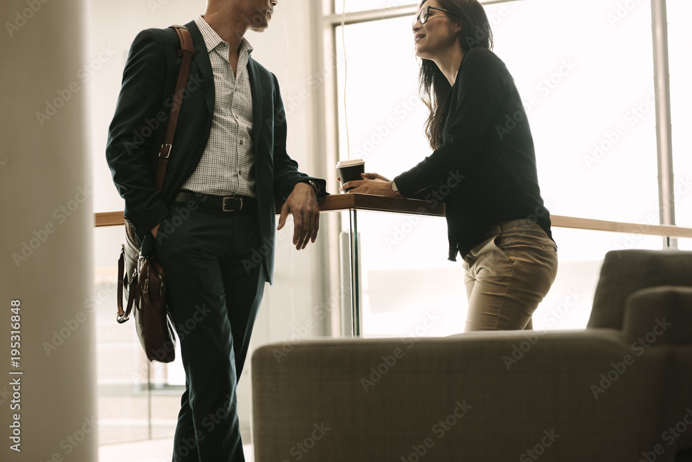 Business colleagues talking in office during break