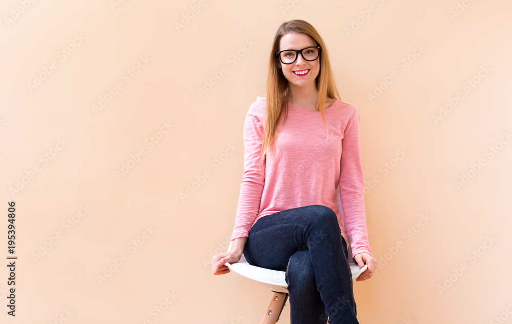 Happy young woman smiling while sitting in a big open room