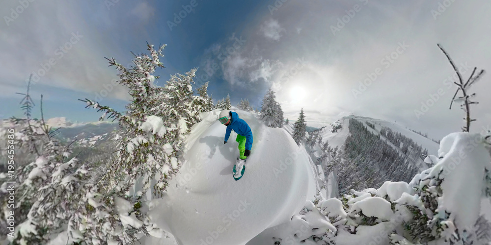 在白雪皑皑的穷乡僻壤中骑着新鲜粉末雪的单板滑雪自由滑运动员