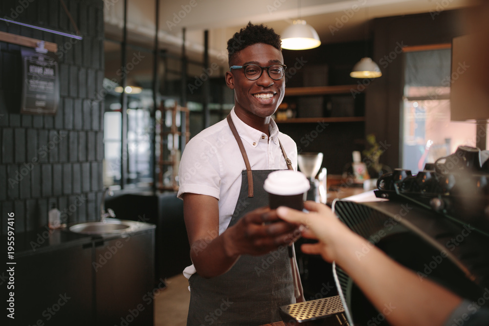 Barista serving customers inside a coffee shop