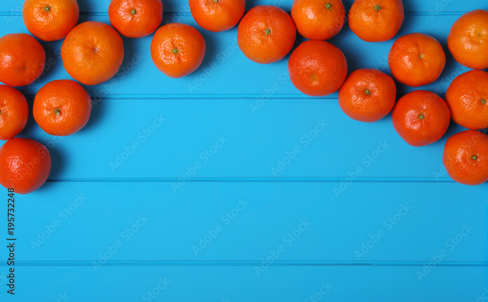 Tangerine on wood table.