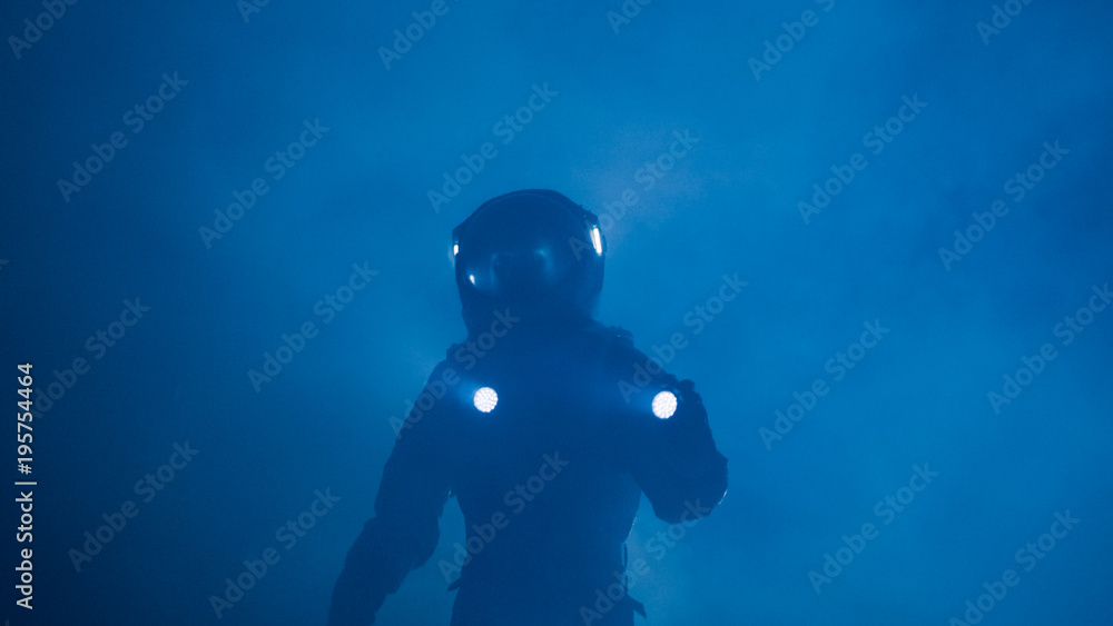 Courageous Astronaut in the Space Suit Holds Flashlight and Explores Misty Alien Planet. Adventure T