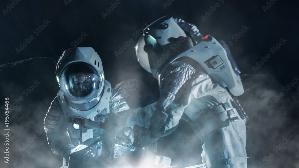 Two Astronauts in Space Suits on an Alien Planet Prepare Space Rover for Surface Exploration Mission