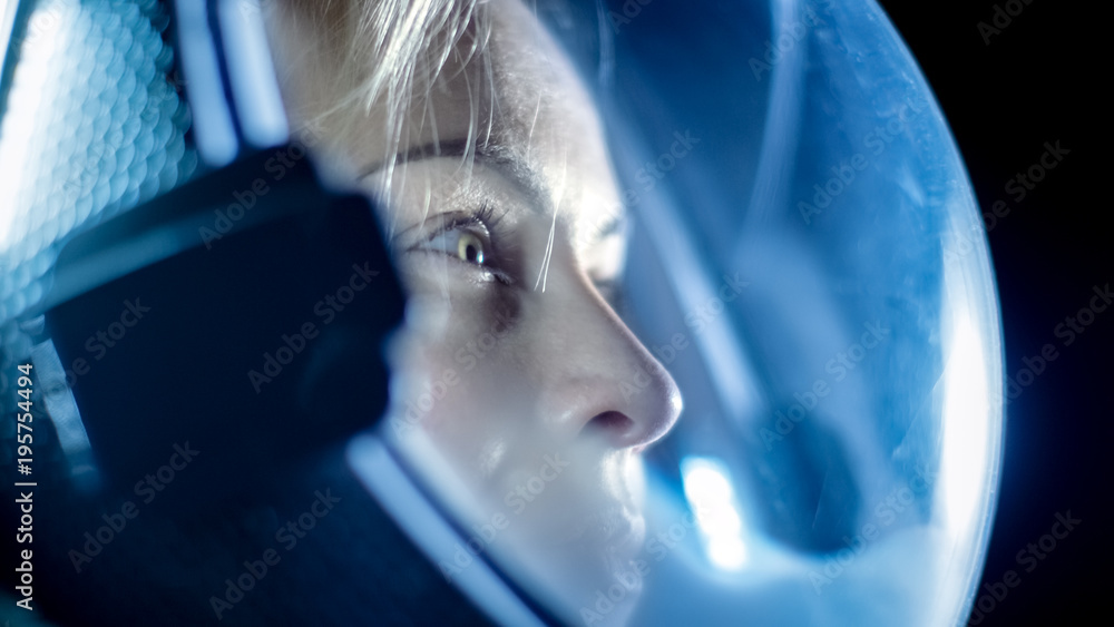 Portrait Shot of the Courageous Female Astronaut  Wearing Helmet in Space, Looking around in Wonder.