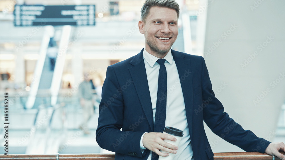 Smiling businessman in a store