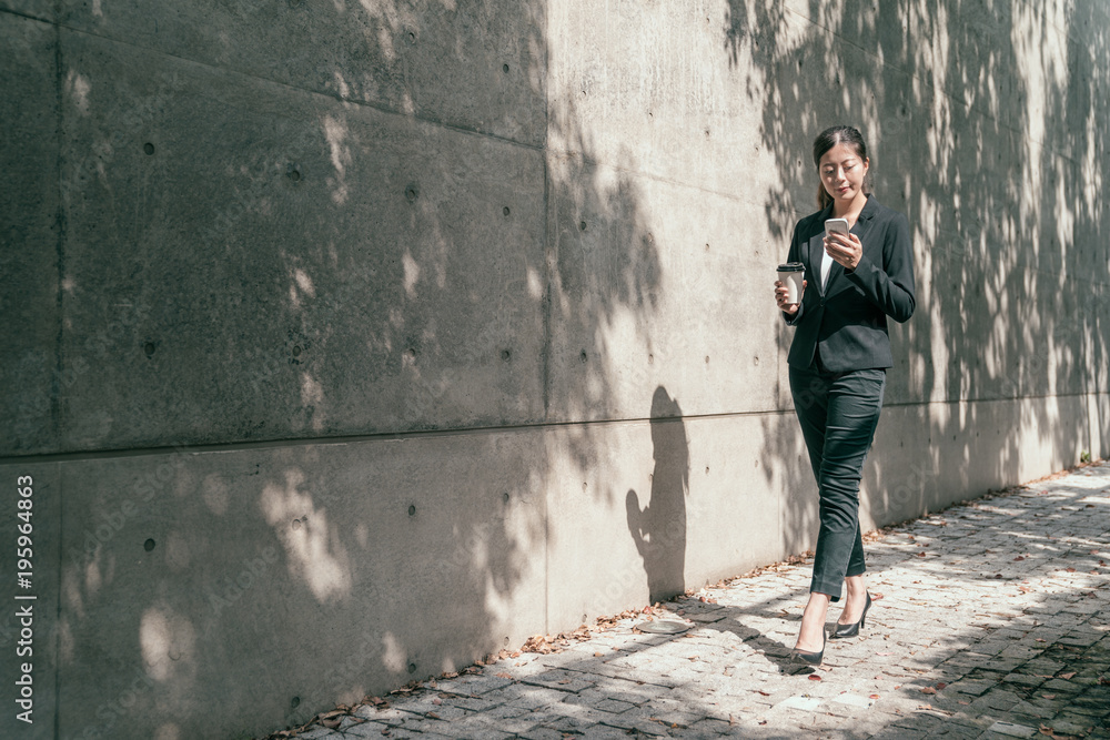 Business woman using phone outdoors