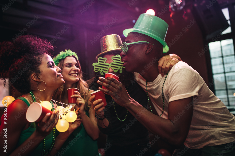 Group of friends celebrating St. Patricks Day at bar