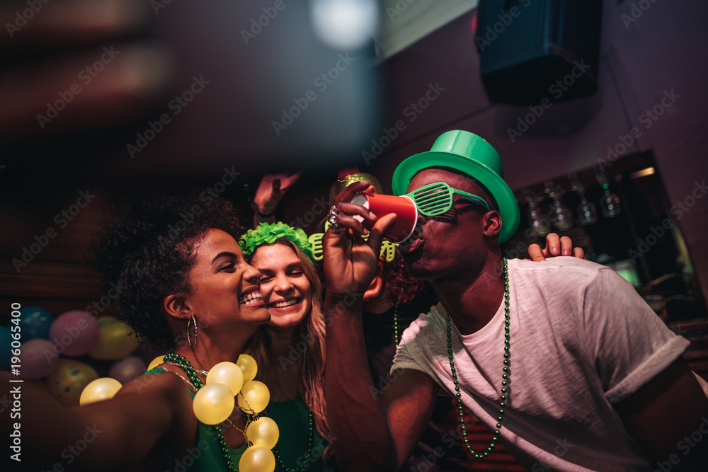 Friends making selfie and enjoying in nightclub