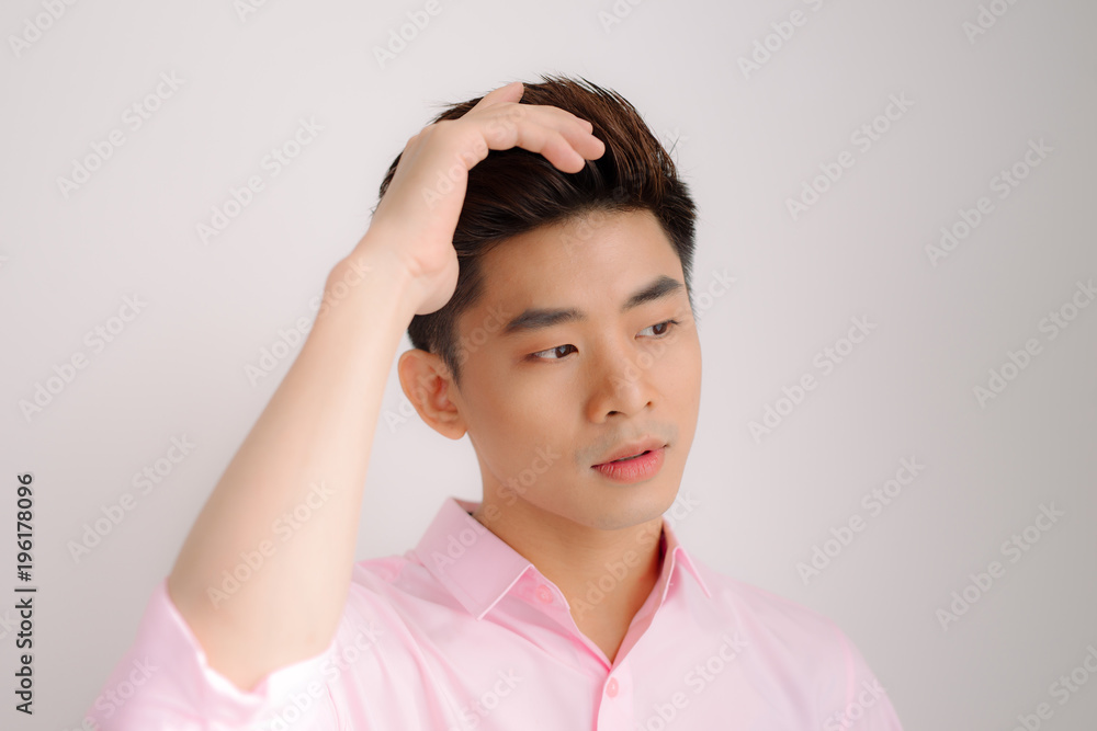 Handsome asian man stand and smile posing on gray background