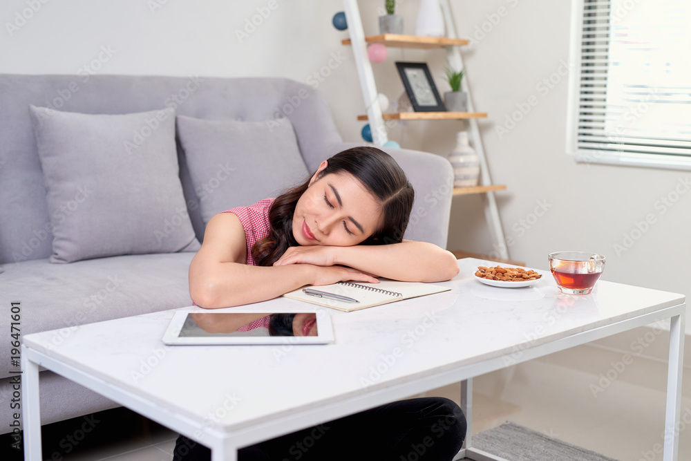 Tired overworked woman resting while she was working writing notes