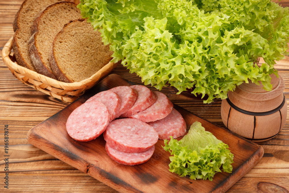 Sliced smoked pork sausage on cutting board