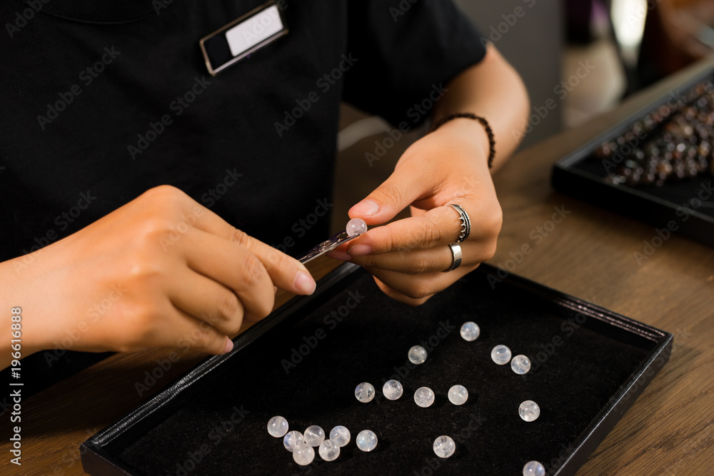 Jeweler making of handmade stone beads jewellery.