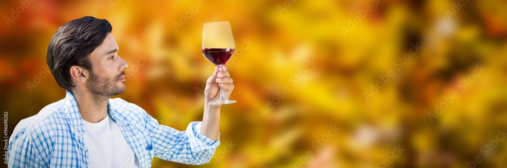 Composite image of man looking at glass of red wine