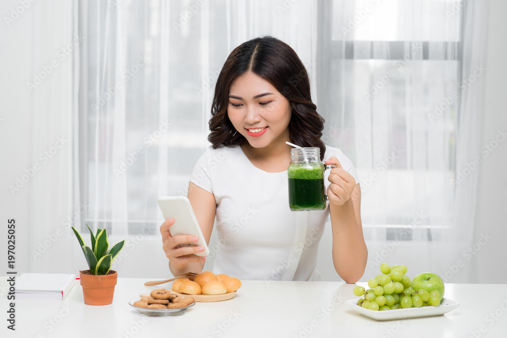 Chit-chat with her friends. Woman talking on her cellphone while having breakfast at her home