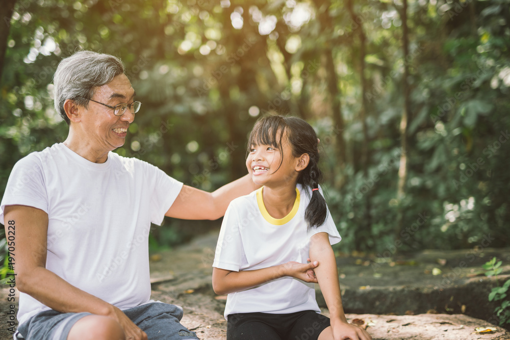 Cute little girl healing massage grandfather