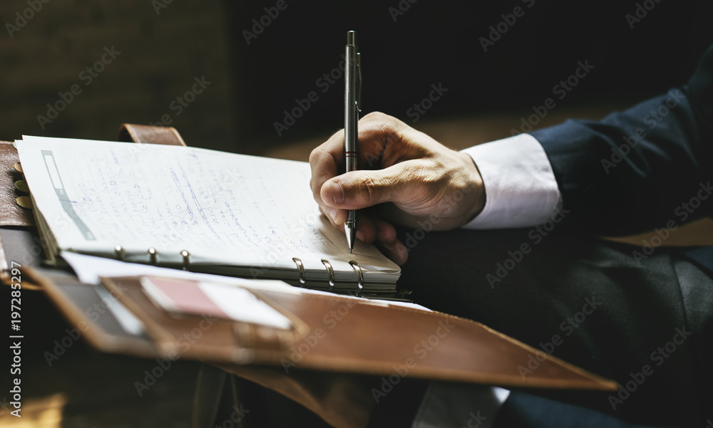 A businessman writing a note