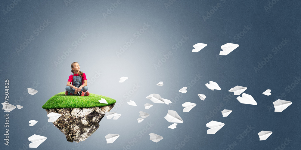 Concept of careless happy childhood with girl and paper planes flying around