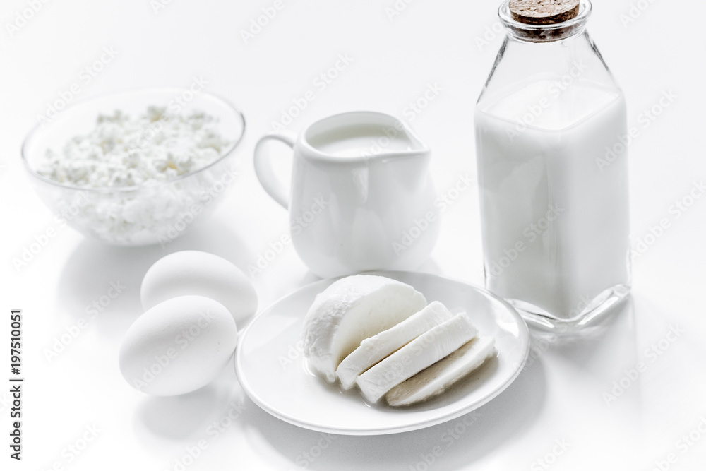 Healthy food concept with milk and cottage cheese on white table