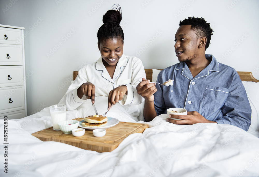 A couple having breakfast in bed