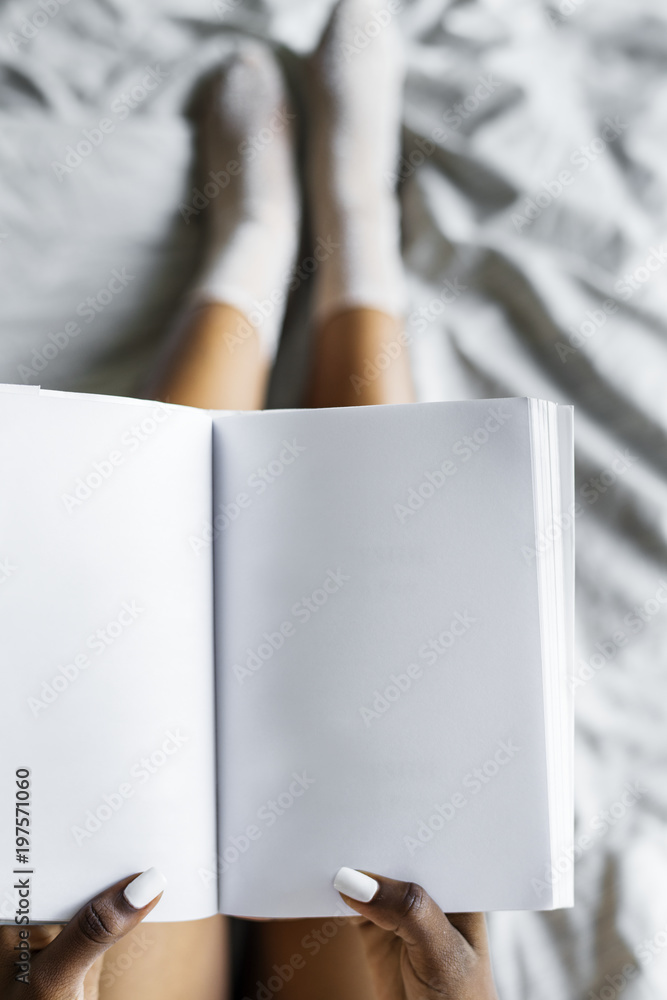 Aerial view of woman holding blank diary