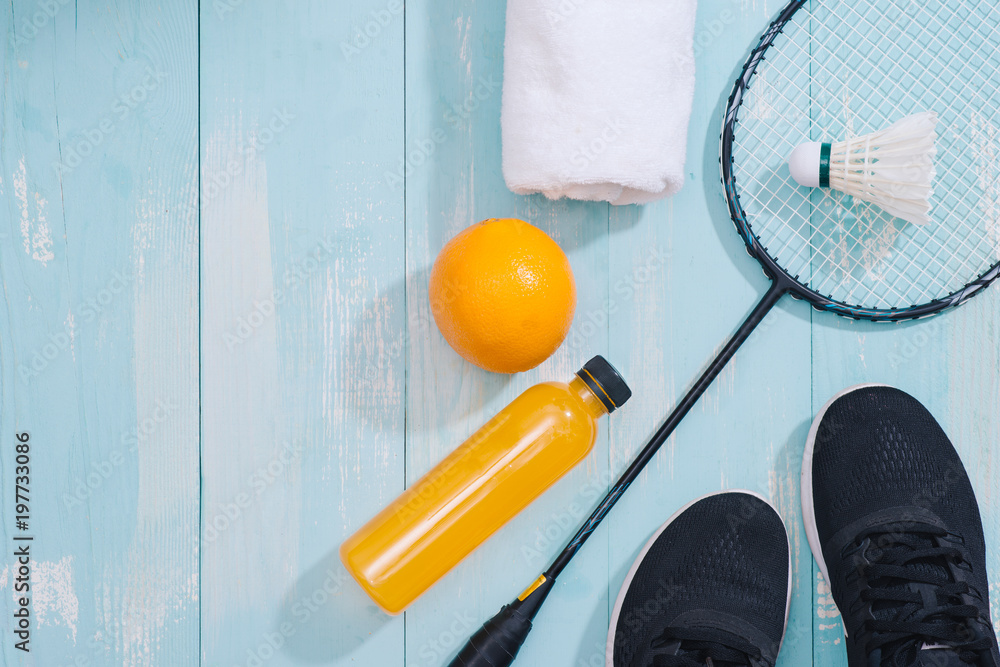 Sport equipment and footwear on wooden background