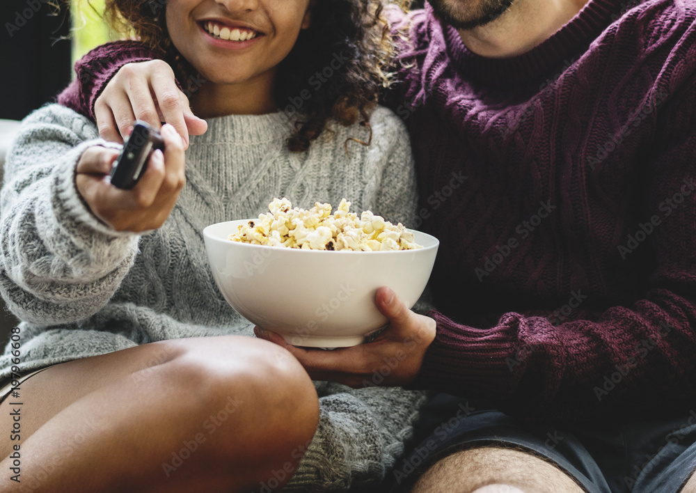 Couple watching TV having popcoprn