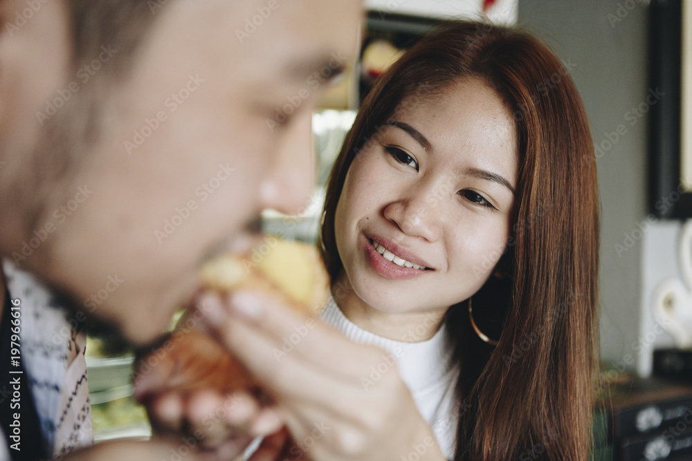 Asian girl feeding her boyfriend