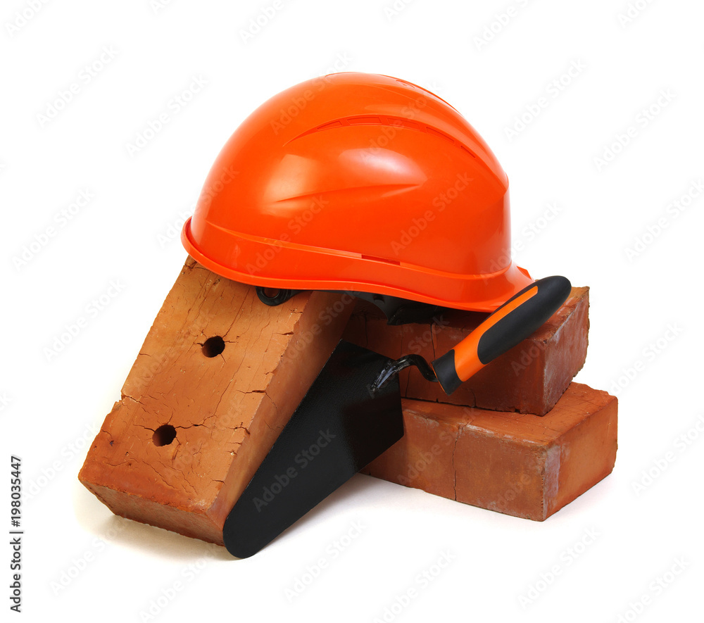 Brick, red hard hat and tools