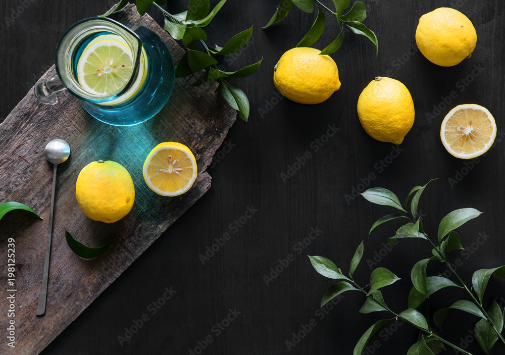 Fresh yellow lemons on black background