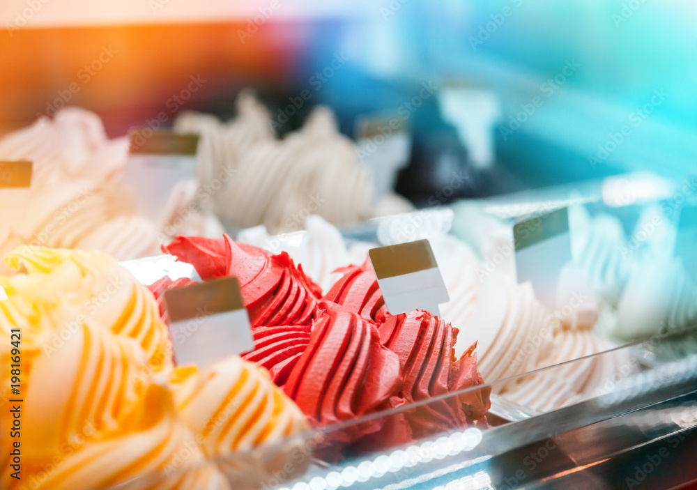 Ice cream in showcase fridge at pastry shop