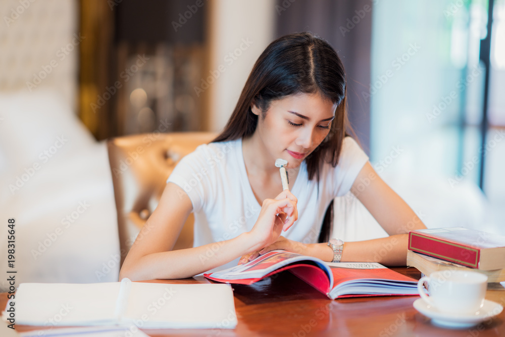 Asian lady student read a text book for prepare to examination on the bedroom, this immage can use f