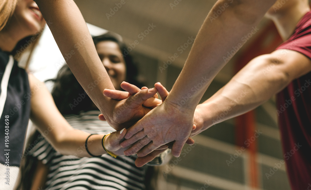 Group of teenager friends on a basketball court teamwork and togetherness concept