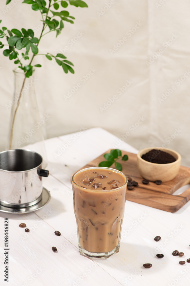 Ice coffee with fresh coffee on a wooden background, Coffee with milk and ice on natural wooden